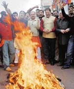 BJP activists burning an effigy of the state government and demanding Presidents rule in Jammu on Tuesday. 