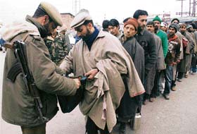 CRPF and Kashmir Police jawans frisking people during search operations in a busy market of Srinagar on Tuesday. 