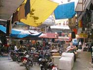 Packets of readymade garments and two-wheelers occupy the street in the congested Akalgarh market in Ludhiana.