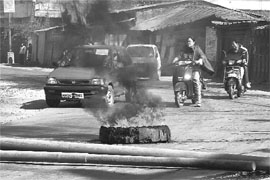 People try to cross the Nongmeibung road in Imphal East District during a 36-hour bandh in Manipur recently. 