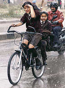 Two schoolgirls caught in winter showers while on their way home from school in Sector 47 in Chandigarh on Thursday.
