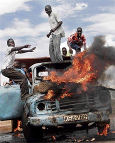 Protesters chant slogans on top of an old burning lorry during a demonstration in the western Kenyan town of Kisumu on Friday.