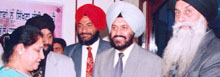 A Punjabi teacher receives award from Pushpinder Singh, member, Delhi Minority Commission, at Punjabi Help Line function in the Capital.