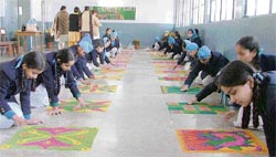 Students of Guru Nanak Public School make their creations during a rangoli competition in Ludhiana