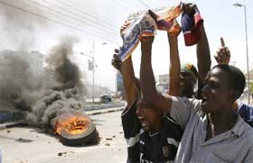 Demonstrators hold posters of opposition Orange Democratic Movement leader Raila Odinga during a protest in the port city of Mombasa