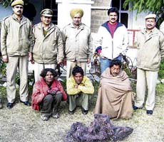 Members of a gang of telephone cable thieves, police personnel and a BSNL official in the police station at Nurpur with recovered copper wire