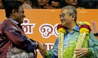 Malaysia's Prime Minister Abdullah Ahmad Badawi (R) is greeted by President of Malaysian Indian Congress (MIC) Samy Vellu (L) at a mass gathering organized by the MIC at a stadium in Kuala Lumpur, on Sunday.