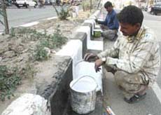 Dividers on the Bathinda-Goniana road get a fresh coat of paint on Monday.
