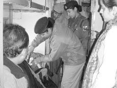 Lady police check the luggage of a train passenger, in view of the approaching Republic Day, in Ambala on Monday.