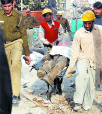 The body of a Metro worker being taken out from the Laxmi Nagar construction site in the Capital 