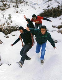 Tourists enjoy themselves at Kufri after fresh snow on Monday.