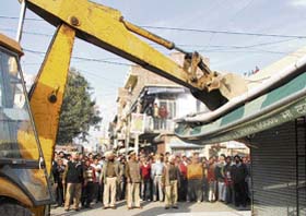 An MC team razes shops in Jawahar Nagar Camp in Ludhiana on Monday.