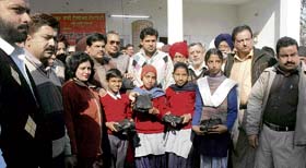 Books being given to poor children in Ludhiana on Monday.