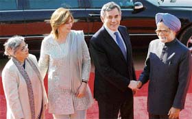 British Prime Minister Gordon Brown, wife Sarah Brown, with Prime Minister Manmohan Singh and his wife Gursharan Kaur pose for the media before the ceremonial guard of honour at the Rashtrapati Bhavan, in New Delhi