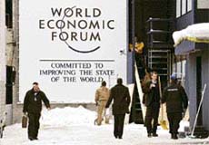 Staff members and security personnel are seen at the back entrance of the 2008 World Economic Forum in Davos on Tuesday.