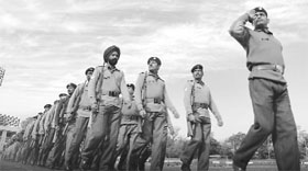 ITBP jawans rehearse for the Republic Day function; and (right) girls rehearse for the function in Patiala