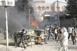Dalit protesters torch a vehicle during a protest march in Rohtak