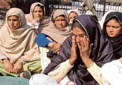 Bhupinder Kaur, widow of Charanjit Singh, of Ghaloti village wipes tears outside the deputy commissioners office in Ludhiana on Wednesday.