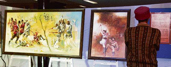 A visitor looks at paintings, based on the 1857 revolt, made by artists of national repute, on display at Kurukshetra University.