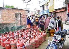 Consumers await refills outside an LPG distribution centre at Nurpur