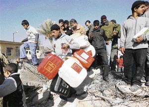 Palestinian men, some carrying empty jerrycans, cross the border to Egypt in the divided city of Rafah on the border between Egypt and the Gaza Strip on Thursday.