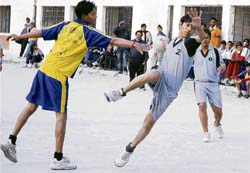 Players in action during the 21st Junior State Handball Championship at DAV SSS-8 in Chandigarh on Friday.