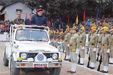 Chief Minister Prem Kumar Dhumal inspects the parade at the 38th Statehood Day function at Sarkaghat (Mandi) on Friday.