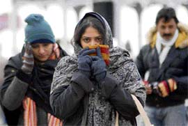 With the mercury hitting an all-time low in Shimla, these girls try to beat cold wrapped fully in woollens on Friday.