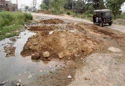 Poor infrastructure and road network (above) have been a major hurdle in the way of realty boom in Baddi area in spite of hectic construction activity (left).