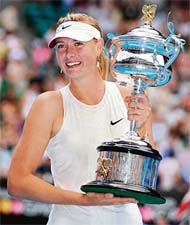 Russian tennis player Maria Sharapova poses with the trophy after victory in womens singles final match