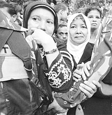 Mourners gather in front of former Indonesian President Suhartos residence in Jakarta on Sunday. 