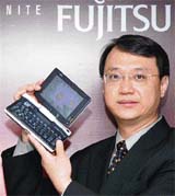 Fujitsu PCs Asia Pacific business development director Ivan Kam poses with the newly launched LifeBook U1010 (3.5G), claimed by the company to be the world's smallest tablet convertible UMPC, in New Delhi on Tuesday. Fujitsu unveiled six premium mobile computing products, priced at Rs 65,000 onwards.