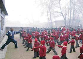 Students of the primary wing of a public school at Kanaid, near Sundernagar, undergo karate training in the sub-zero temperature on Tuesday morning