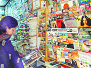 A woman checks out a magazine at a book store in Jalandhar.