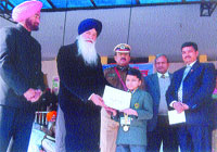 Aakarshan Gupta, a student of MGN Public School, being awarded at the Republic Day function at Guru Gobind Singh Stadium in Jalandhar.