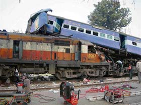 A coach of Jananayak Express lies on top of the engine of a goods train after the express train rammed into it at Bodarwar station on the Narkatiyaganj-Gorakhpur section in Uttar Pradesh