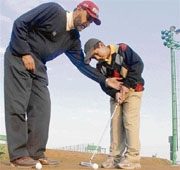 Feroz gets putting lessons from his coach Jesse Grewal in Chandigarh.