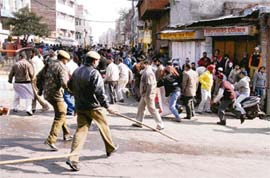 The police cane-charges members of the Jammu and Kashmir Employees Joint Action Committee during a protest demonstration in front of the civil secretariat in Jammu on Wednesday.