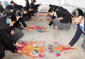 Students of Guru Nanak Public School take part in the rangoli competition organised on school premises in Ludhiana