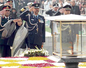 President Prathiba Singh Patil is flanked by armed forces chiefs as they salute at Rajghat on Martyrs Day in New Delhi on Wednesday.
