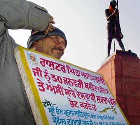 A Congress worker salutes Mahatma Gandhi on his martyrdom day at Company Bagh in Amritsar