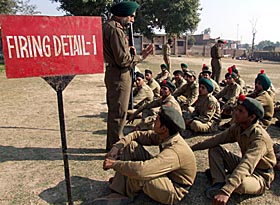 Camp Commandant Satnam Singh tells NCC cadets about firearms during a camp held at Lopoke village in Amritsar. 