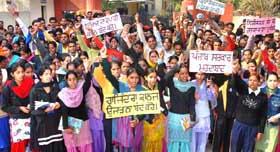 Students of Rajindra College, Bathinda, stage a protest against the alleged proposal to shift the college, on Friday.