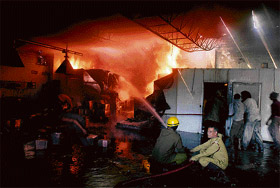 Fire-fighters trying to extinguish a fire that broke out in a factory in Bari Brahmana at Jammu on Friday.