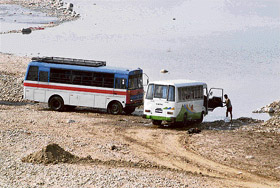 Despite a ban, police personnel are seen washing vehicles in the River Tawi at Jammu on Friday.