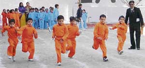 Students of Kundan Vidya Mandir, city branch, take part in a race in Ludhiana on Friday.