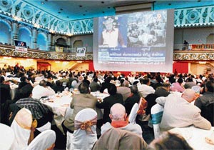 Gujarat Chief Minister Narendra Modi addresses his supporters from Gandhinagar live via satellite on a huge screen in a banquet hall of Albert palace in New Jersey on Friday.