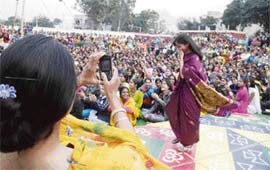 PHOTO IN PHOTO: A student takes a picture while her batchmate performs during a farewell function organised at Government Secondary School, Shastri Nagar, in Jammu.
