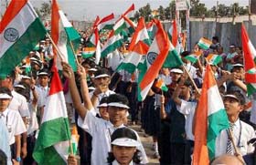 Students hold the Tricolour while participating in the Leadership Parade on the occasion of International Student Leadership Day on the Peoples Plaza Necklace road in Hyderabad