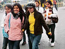 Tourist girls walk in the light showers in Amritsar on Sunday morning. 